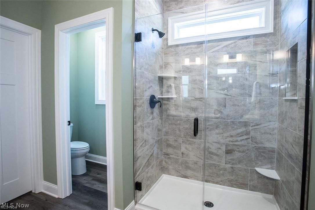34286 Brookside Lane North Ridgeville, OH 44039 - Photo 27 of 50 Full bath with healthy amount of natural light, a stall shower, and dark wood-style floors