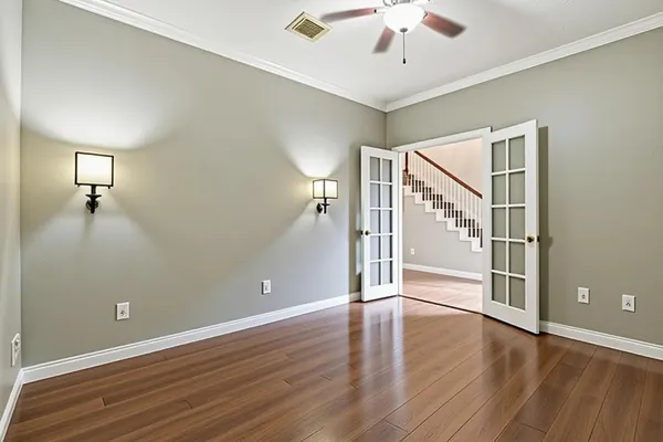 a spacious bedroom with a bed and a chandelier