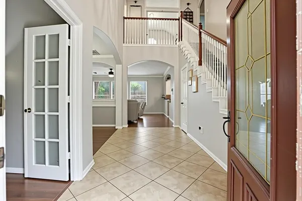 a view of a dining room with furniture and a chandelier