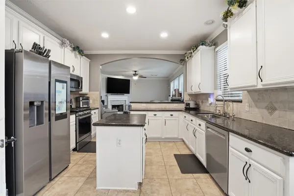 a view of a dining room with furniture large windows and wooden floor