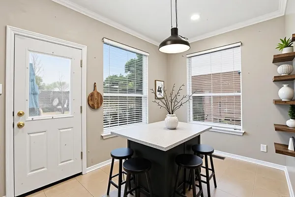 a kitchen with stainless steel appliances a refrigerator sink and white cabinets