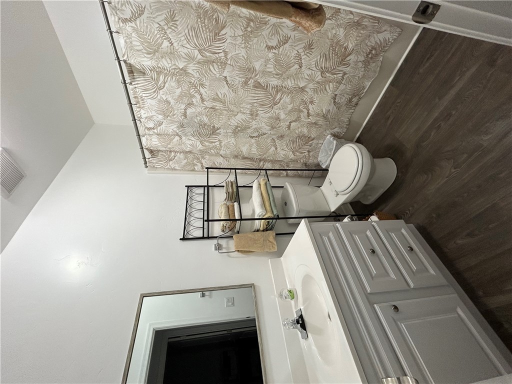 2191 Seneca Street Kingman, AZ 86401 - Photo 24 of 26 a bathroom with a toilet a sink and a mirror
