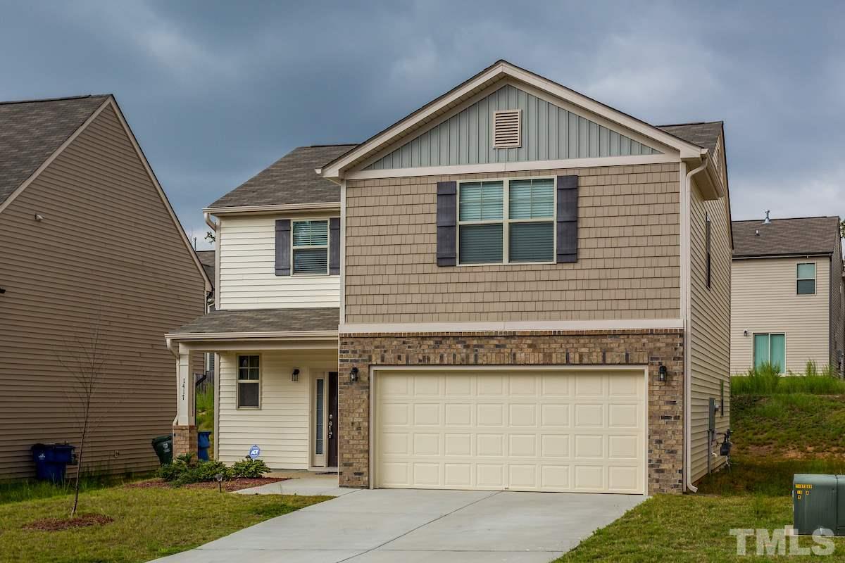 1417 Lombar Street Raleigh, NC 27610 - Photo 2 of 19 a front view of a house with a yard and garage