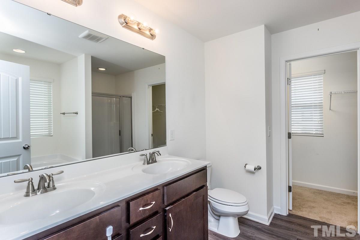 1417 Lombar Street Raleigh, NC 27610 - Photo 16 of 19 a bathroom with a sink a toilet and a mirror