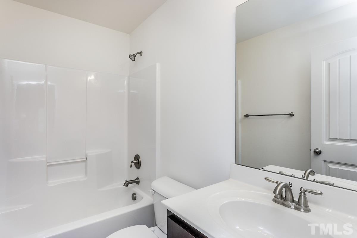 1417 Lombar Street Raleigh, NC 27610 - Photo 17 of 19 a bathroom with a sink and a bathtub