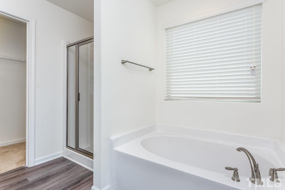 1417 Lombar Street Raleigh, NC 27610 - Photo 19 of 19 a white bath tub sitting next to a window
