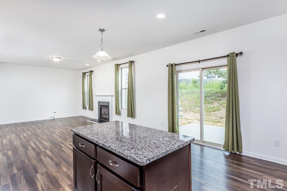 1417 Lombar Street Raleigh, NC 27610 - Photo 8 of 19 a kitchen with sink cabinets and wooden floor
