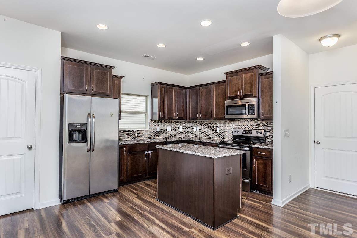 1417 Lombar Street Raleigh, NC 27610 - Photo 10 of 19 a kitchen with stainless steel appliances granite countertop a refrigerator and a stove