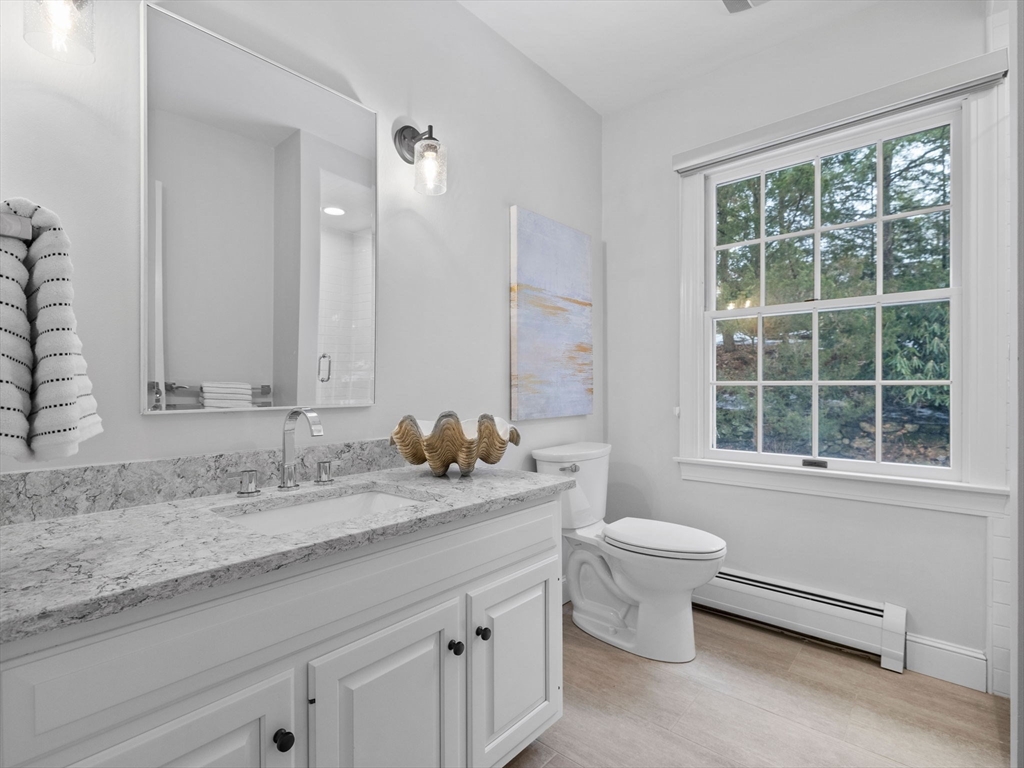 10 Livingston Road Wellesley, MA 02482 - Photo 16 of 36 a bathroom with a granite countertop sink and a mirror