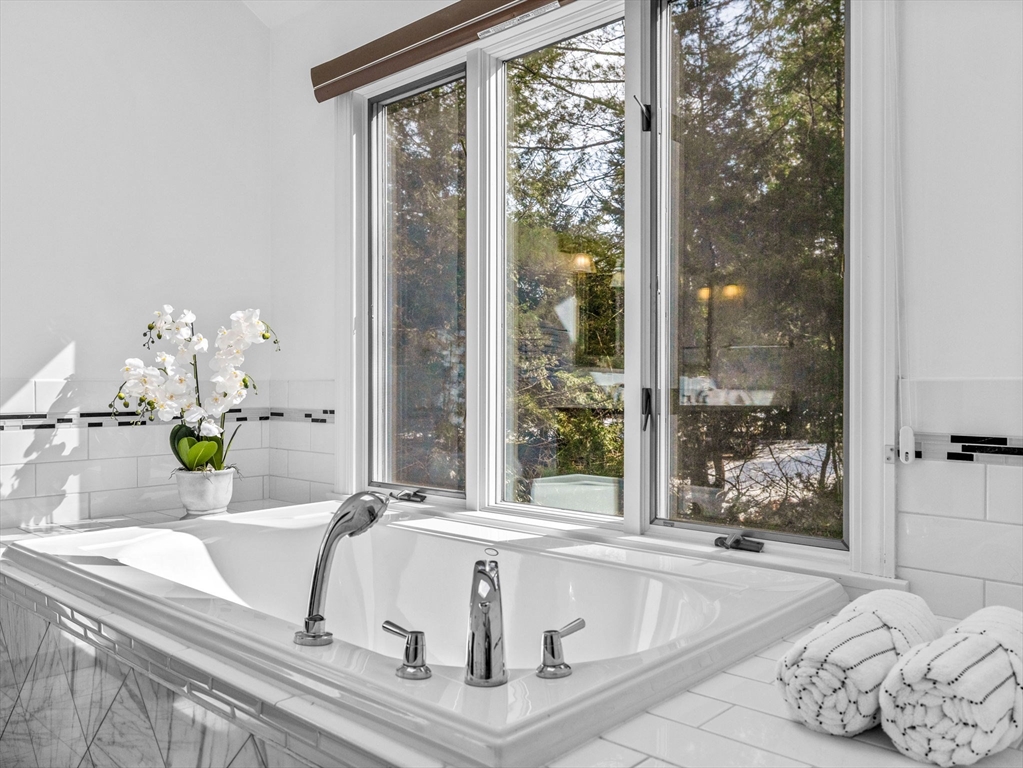 10 Livingston Road Wellesley, MA 02482 - Photo 21 of 36 a white bath tub sitting in a bathroom next to a window