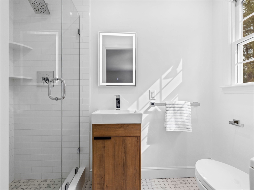 10 Livingston Road Wellesley, MA 02482 - Photo 27 of 36 a bathroom with a sink a toilet and shower