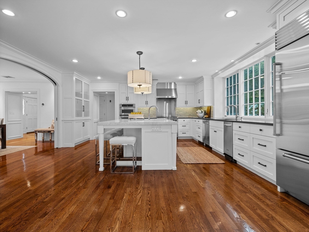 10 Livingston Road Wellesley, MA 02482 - Photo 10 of 36 a kitchen with stainless steel appliances kitchen island wooden floors and view living room