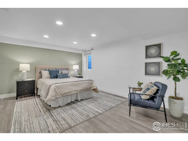 a bedroom with a bed and a potted plant