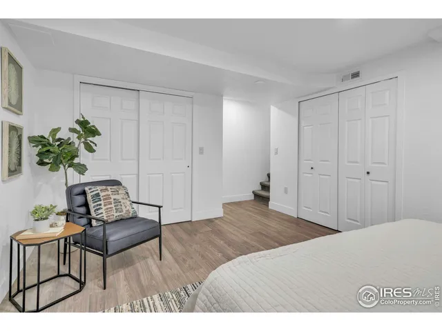 a bedroom with a bed and a chair