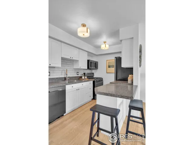 a kitchen with a sink cabinets and window