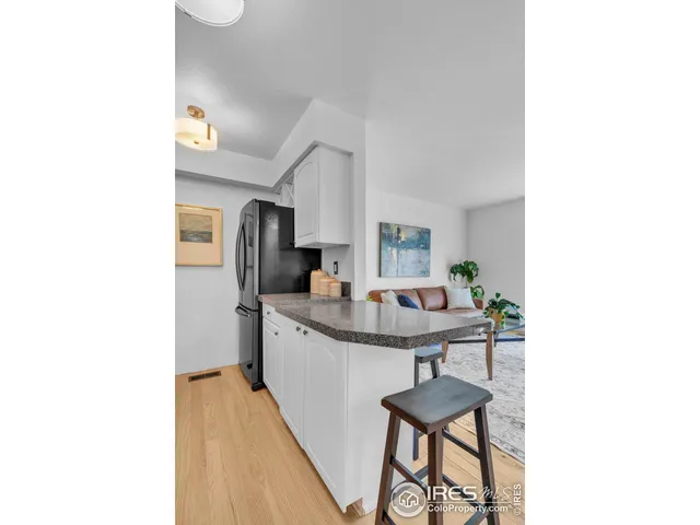 a kitchen with stainless steel appliances granite countertop a sink and a refrigerator