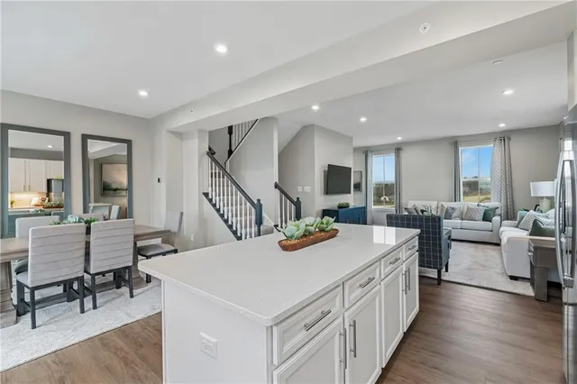 a kitchen with kitchen island a refrigerator stove microwave and cabinets
