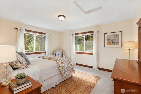 a bedroom with a bed couch and window