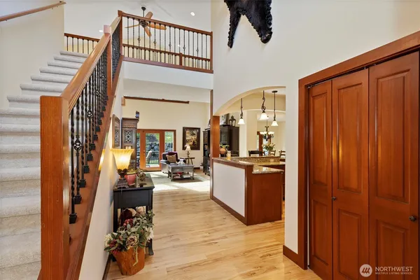 a view of a hallway with wooden floor and staircase