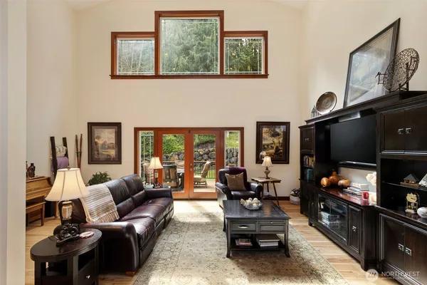 a living room with furniture a flat screen tv and a table