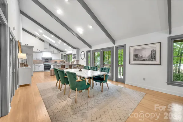 a kitchen with stainless steel appliances granite countertop a stove and white cabinets