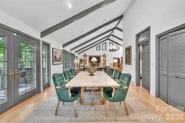 a living room with a bed and dresser with wooden floor