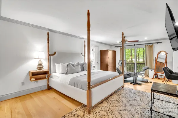 a bedroom with a bed couch and window