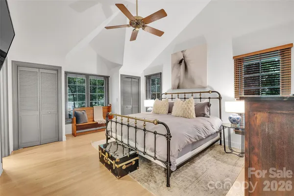 a bed room with a bed and a chandelier