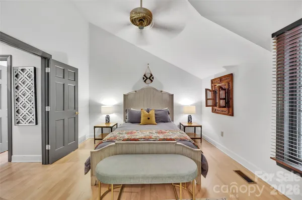 a bedroom with a bed and a flat tv screen