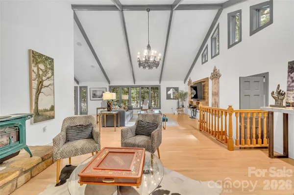 a living room with furniture and floor to ceiling windows