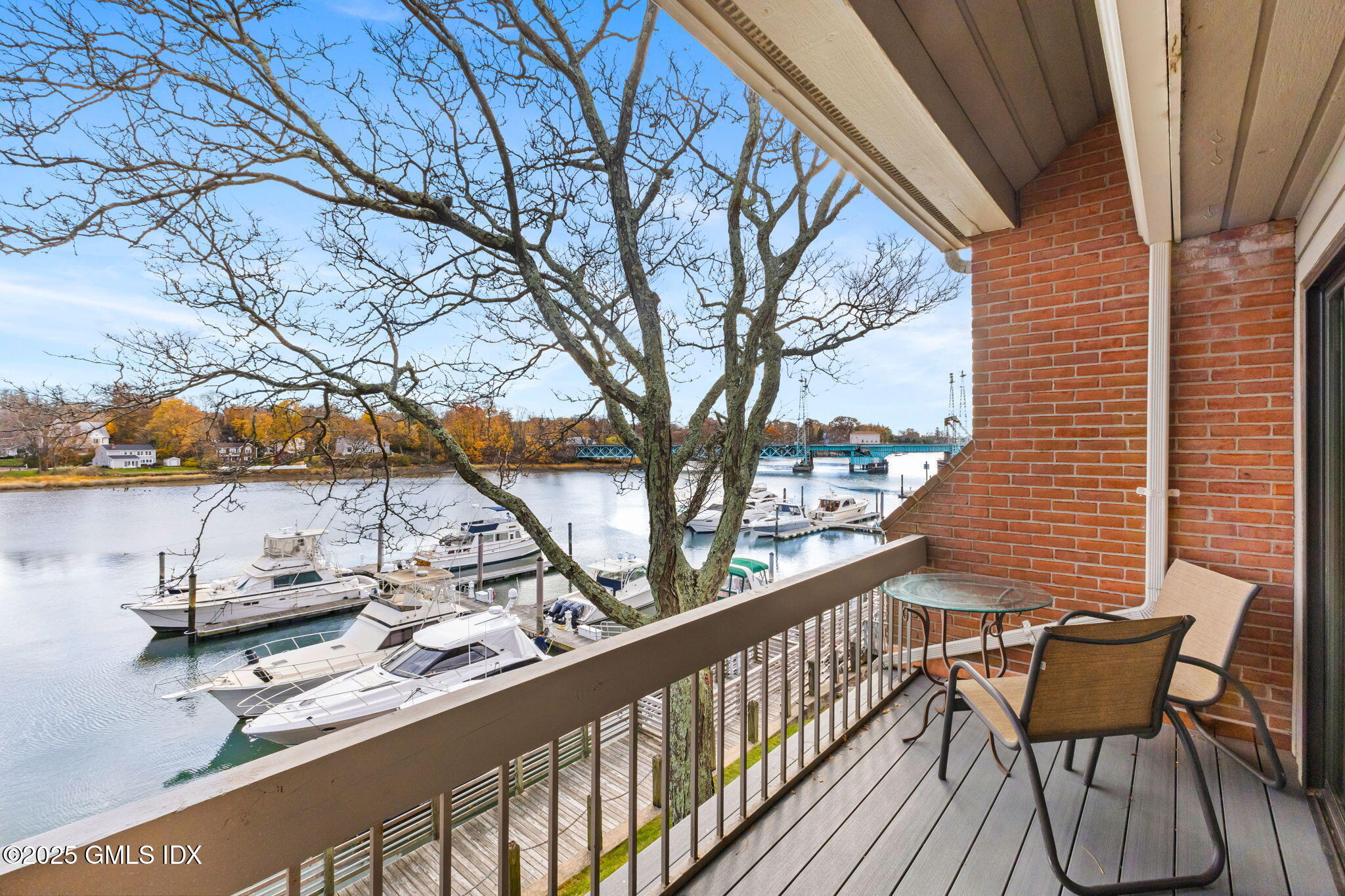 11 River Road, Unit 105 Cos Cob, CT 06807 - Photo 11 of 20 a view of a chairs and table in the balcony