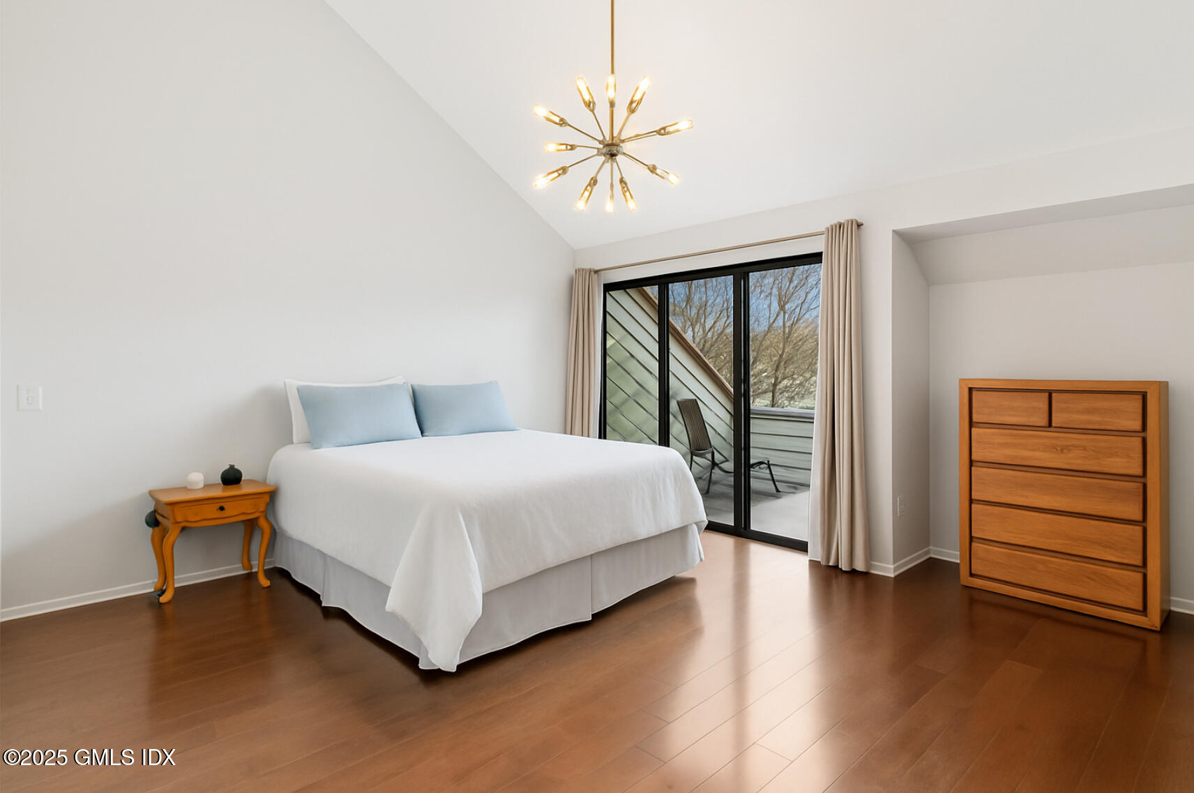 11 River Road, Unit 105 Cos Cob, CT 06807 - Photo 15 of 20 a bedroom with a bed and a table