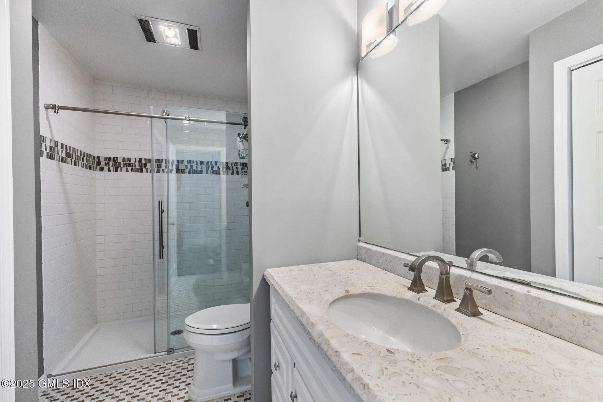 11 River Road, Unit 105 Cos Cob, CT 06807 - Photo 16 of 20 a bathroom with a granite countertop sink toilet and shower