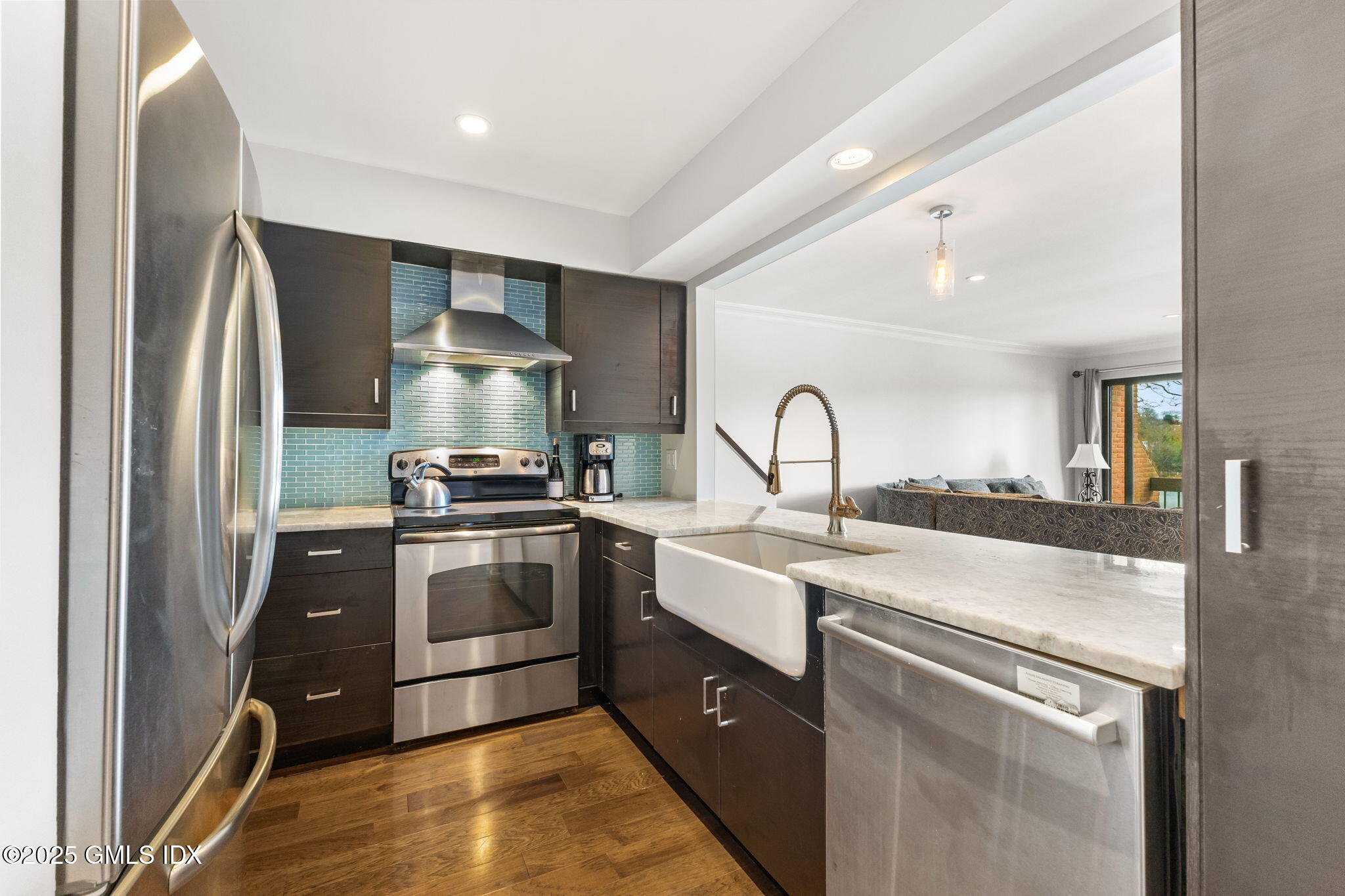11 River Road, Unit 105 Cos Cob, CT 06807 - Photo 3 of 20 a kitchen with stainless steel appliances granite countertop a sink stove and refrigerator