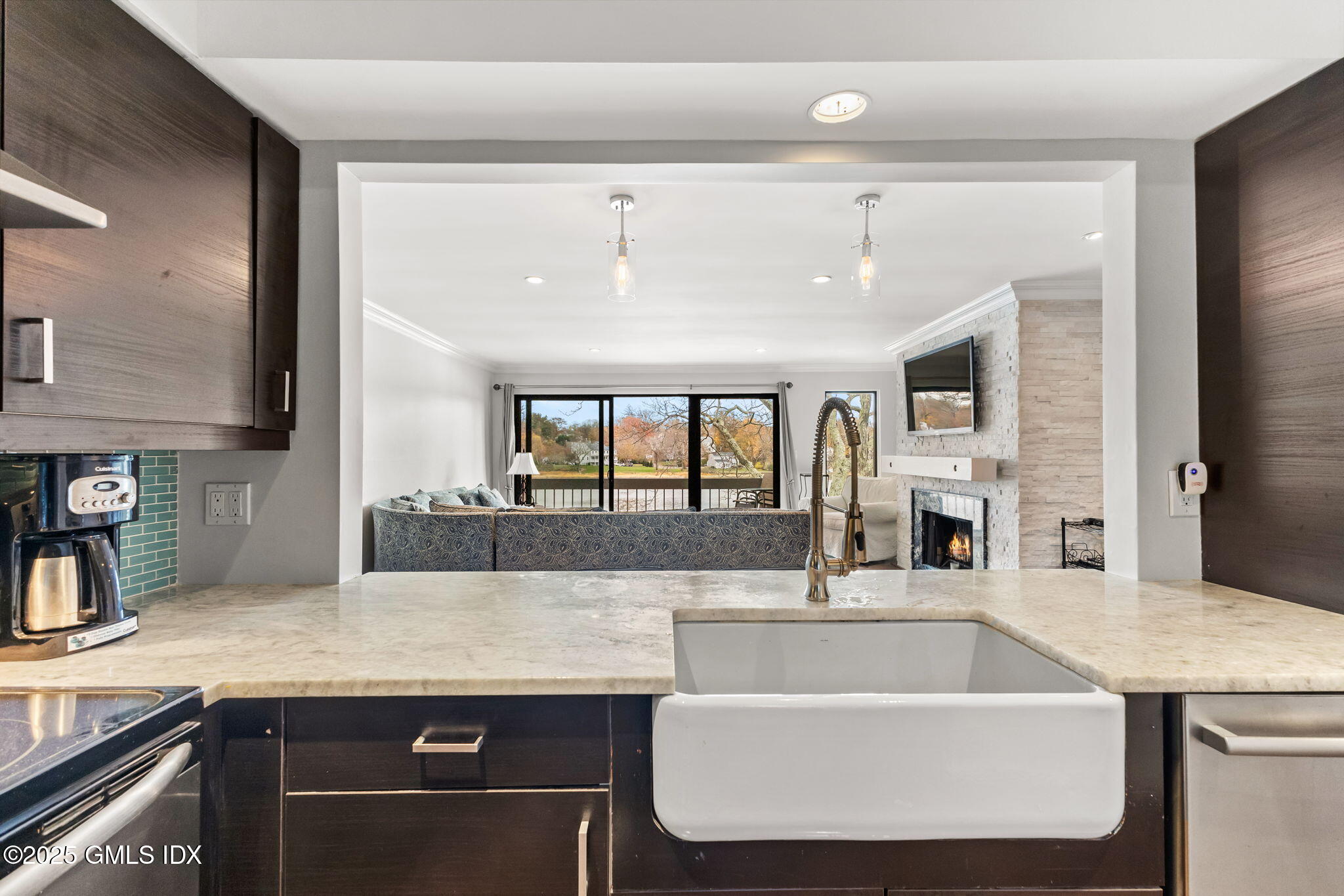 11 River Road, Unit 105 Cos Cob, CT 06807 - Photo 4 of 20 a large kitchen with kitchen island a sink stainless steel appliances and cabinets