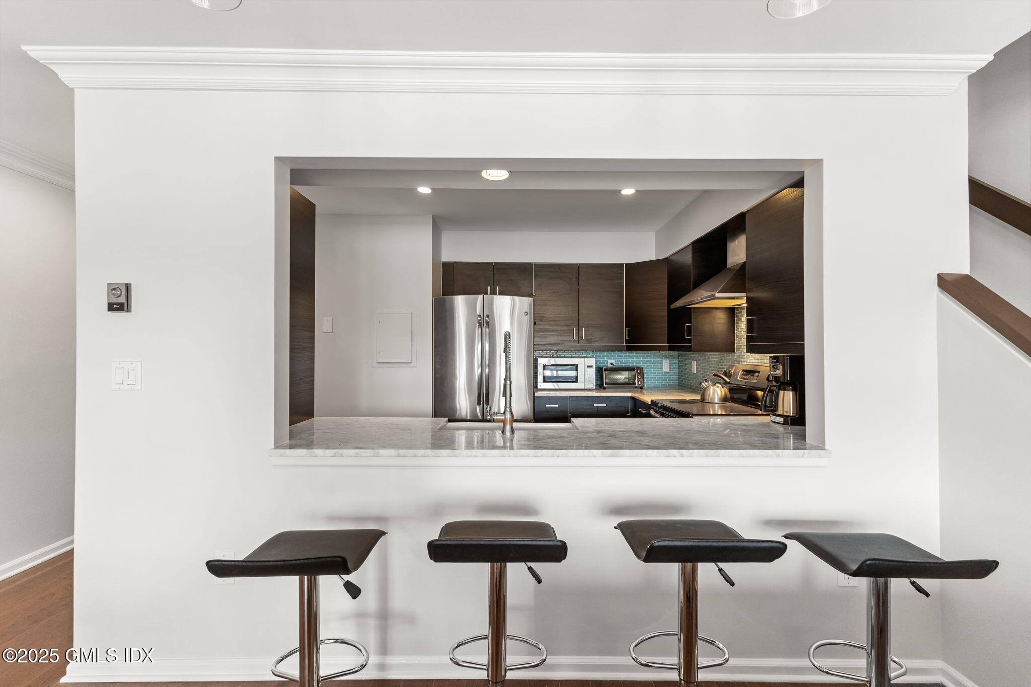 11 River Road, Unit 105 Cos Cob, CT 06807 - Photo 5 of 20 a kitchen with cabinets and chairs