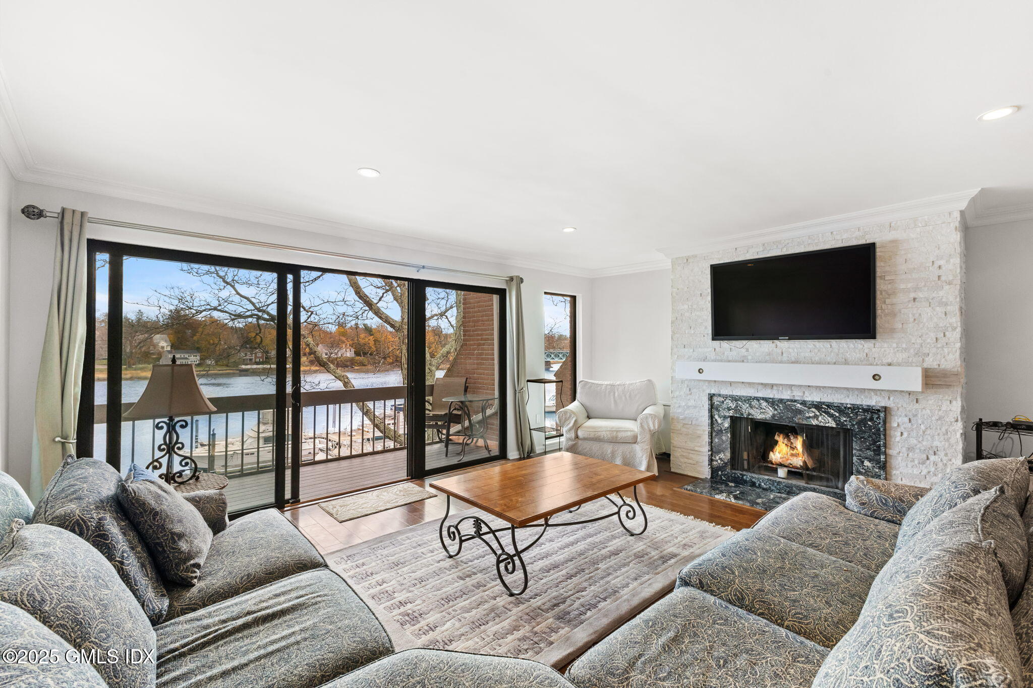 11 River Road, Unit 105 Cos Cob, CT 06807 - Photo 7 of 20 a living room with furniture fireplace and a large window
