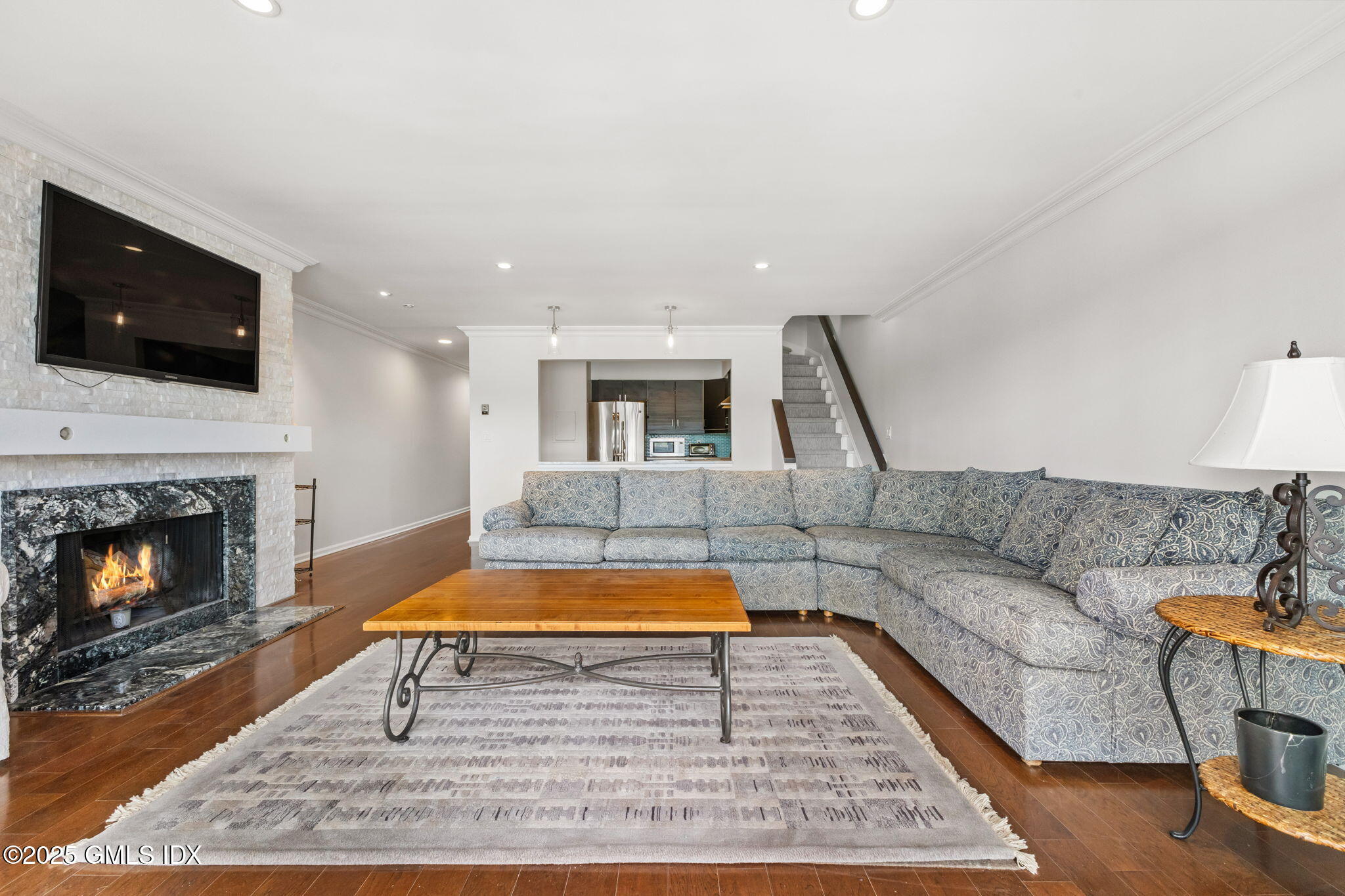 11 River Road, Unit 105 Cos Cob, CT 06807 - Photo 8 of 20 a living room with furniture and a fireplace