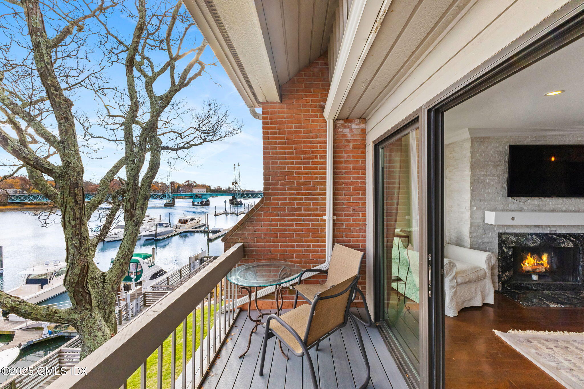 11 River Road, Unit 105 Cos Cob, CT 06807 - Photo 10 of 20 a view of a balcony with furniture and wooden floor