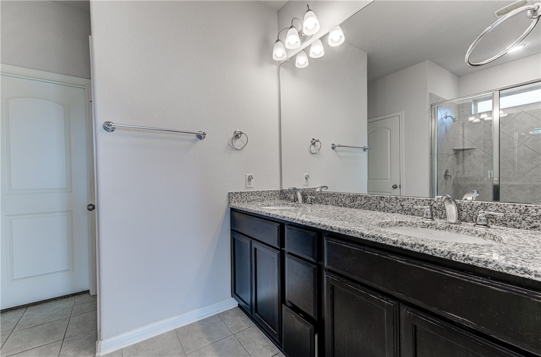 2709 Fortezza Way Round Rock, TX 78665 - Photo 15 of 39 a bathroom with a granite countertop sink and a mirror