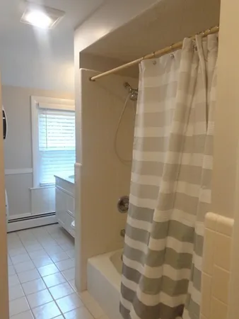 a bathroom with a shower and a sink