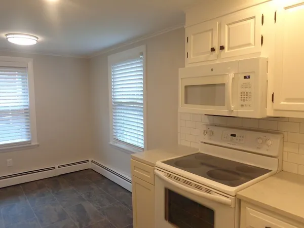 a stove top oven sitting inside of a kitchen