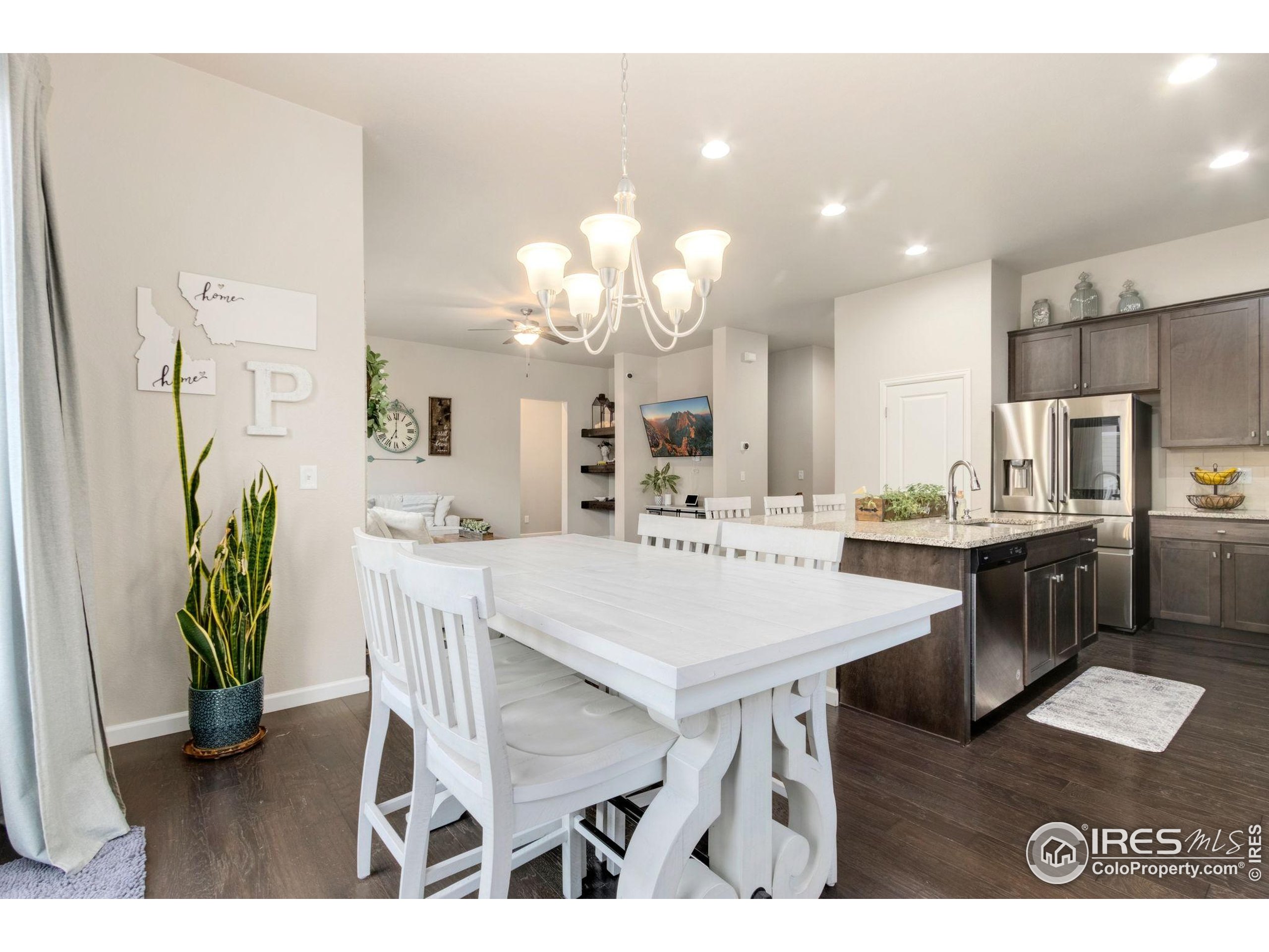 719 Wagon Bend Road Berthoud, CO 80513 - Photo 16 of 40 a view of a dining room with furniture and a chandelier
