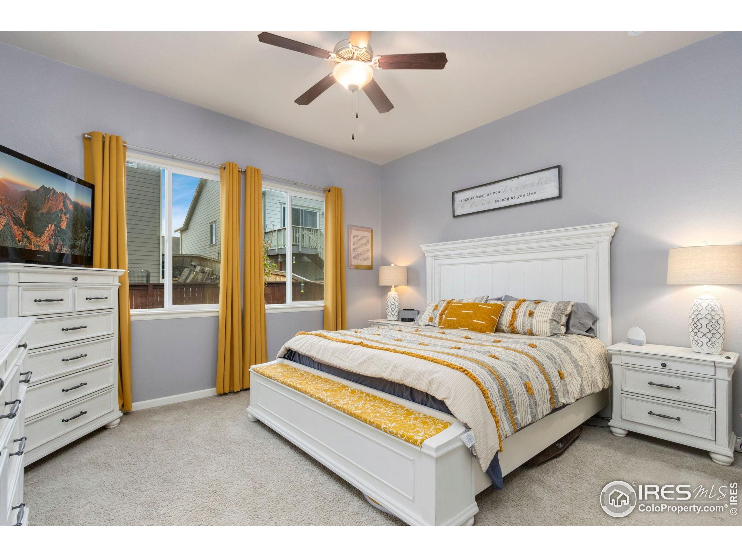 719 Wagon Bend Road Berthoud, CO 80513 - Photo 17 of 40 a spacious bedroom with a bed and a flat screen tv