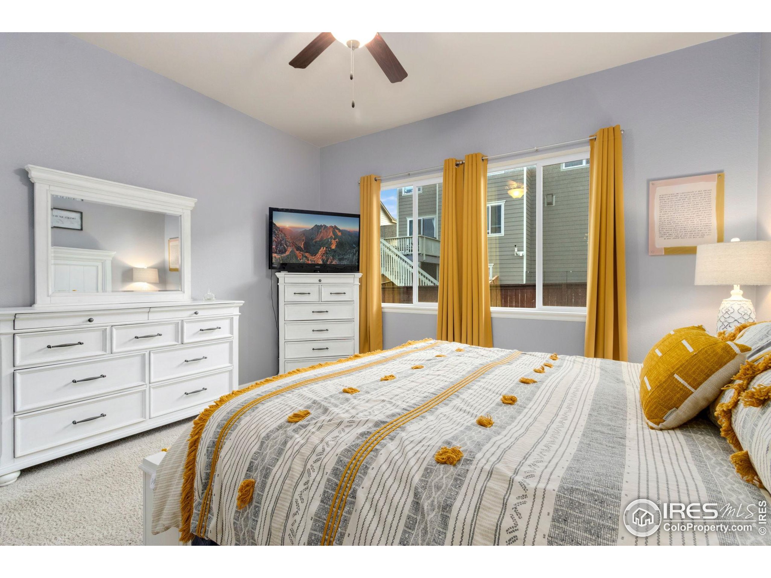 719 Wagon Bend Road Berthoud, CO 80513 - Photo 18 of 40 a bedroom with a bed and a dresser