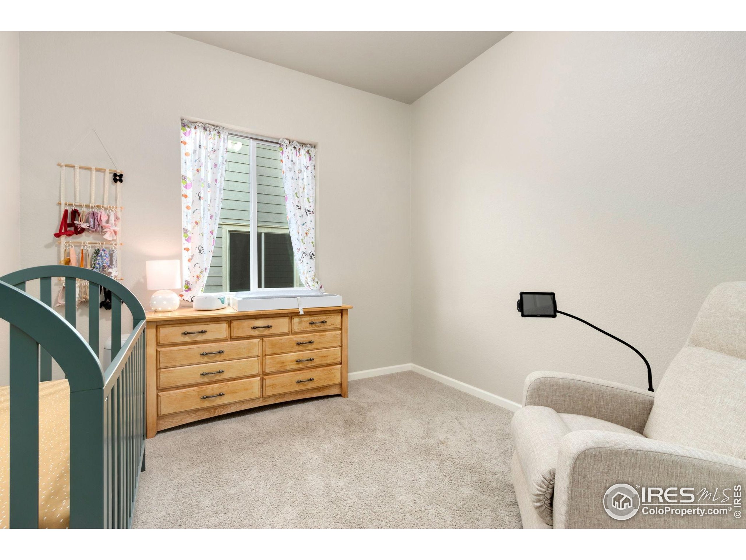 719 Wagon Bend Road Berthoud, CO 80513 - Photo 22 of 40 a bedroom with a bed and a dresser