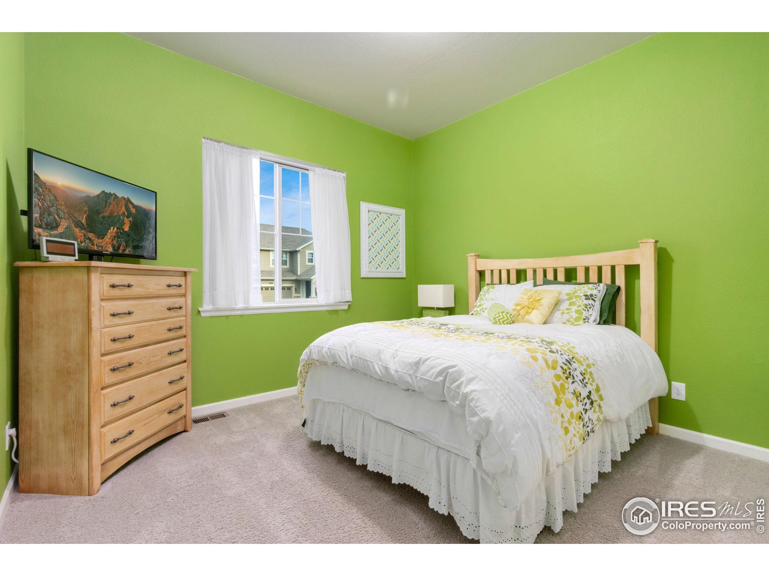 719 Wagon Bend Road Berthoud, CO 80513 - Photo 24 of 40 a bedroom with a bed and a window