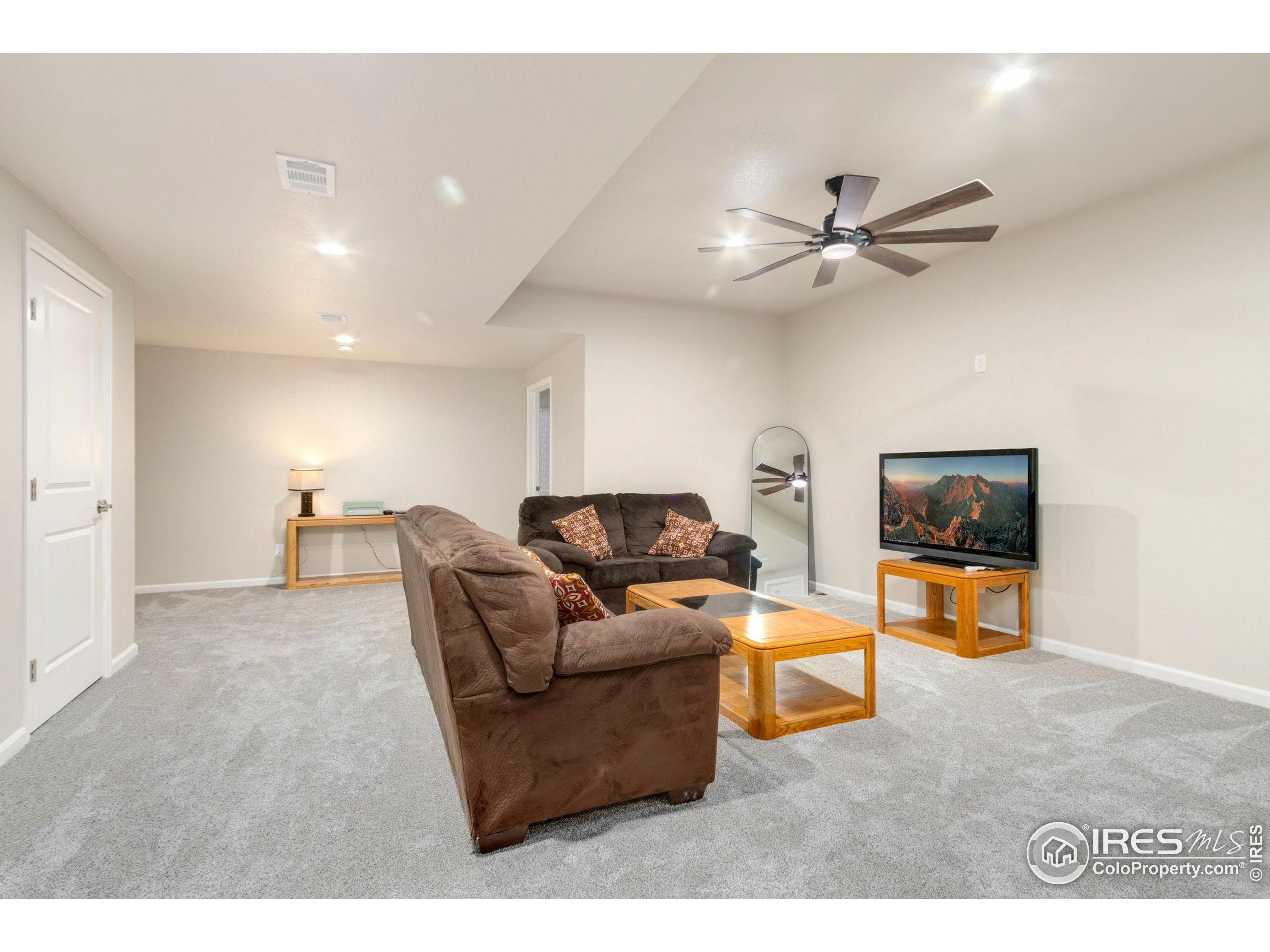 719 Wagon Bend Road Berthoud, CO 80513 - Photo 27 of 40 a living room with furniture and a flat screen tv