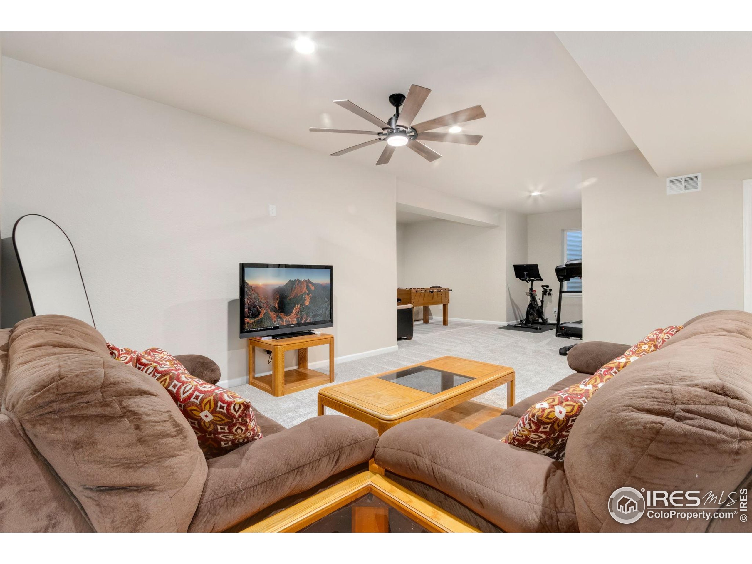 719 Wagon Bend Road Berthoud, CO 80513 - Photo 28 of 40 a living room with furniture and a flat screen tv