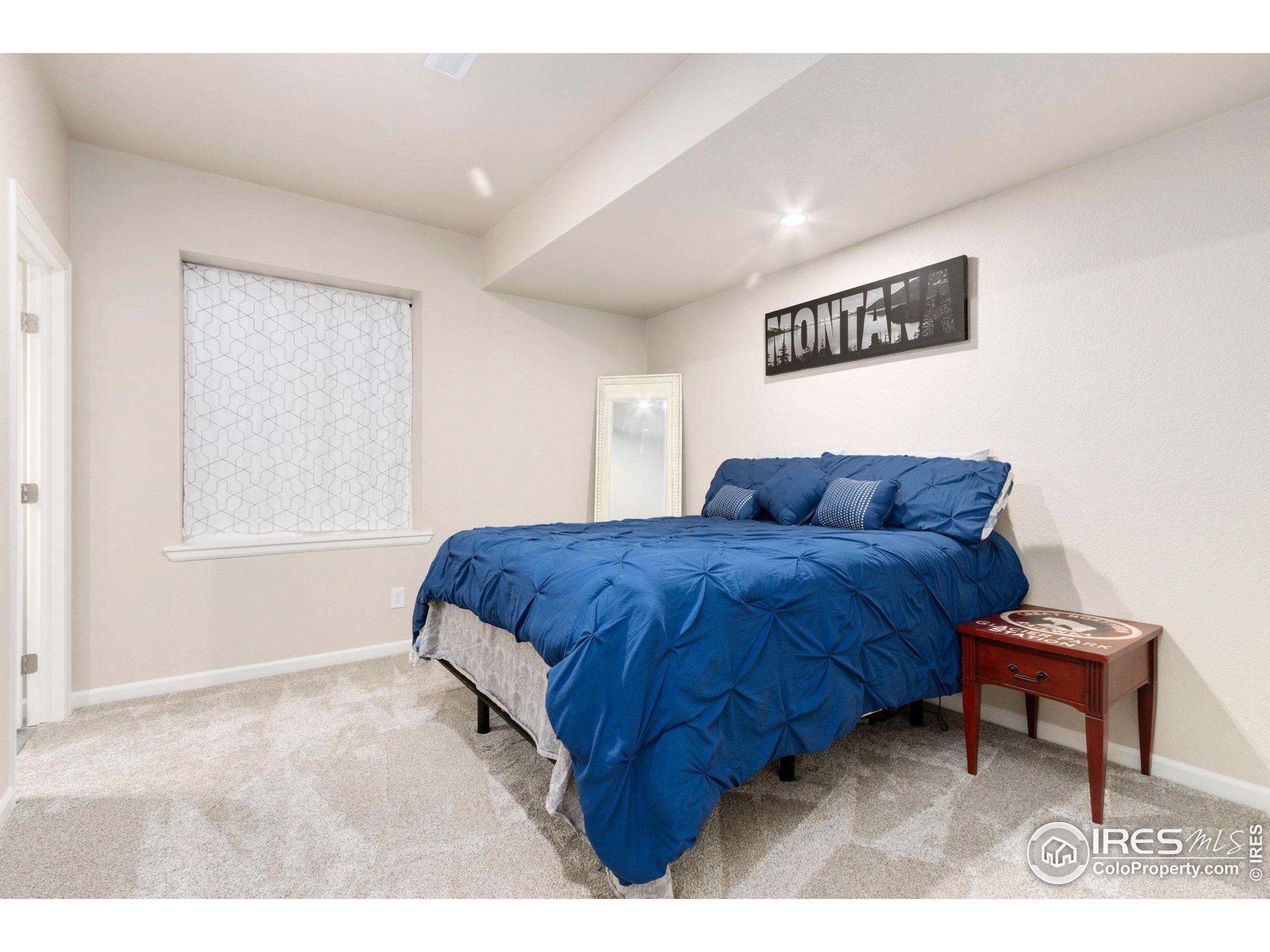719 Wagon Bend Road Berthoud, CO 80513 - Photo 29 of 40 a living room with a bed furniture and a window